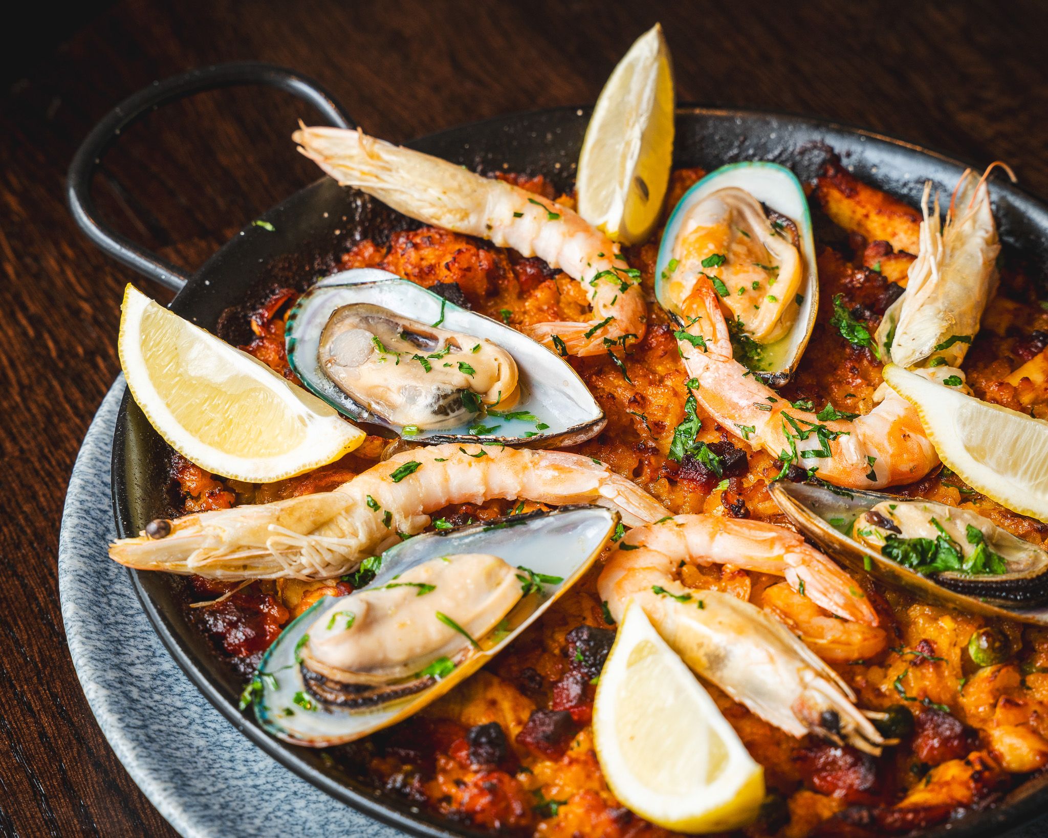 Seafood paella presented in a traditional pan