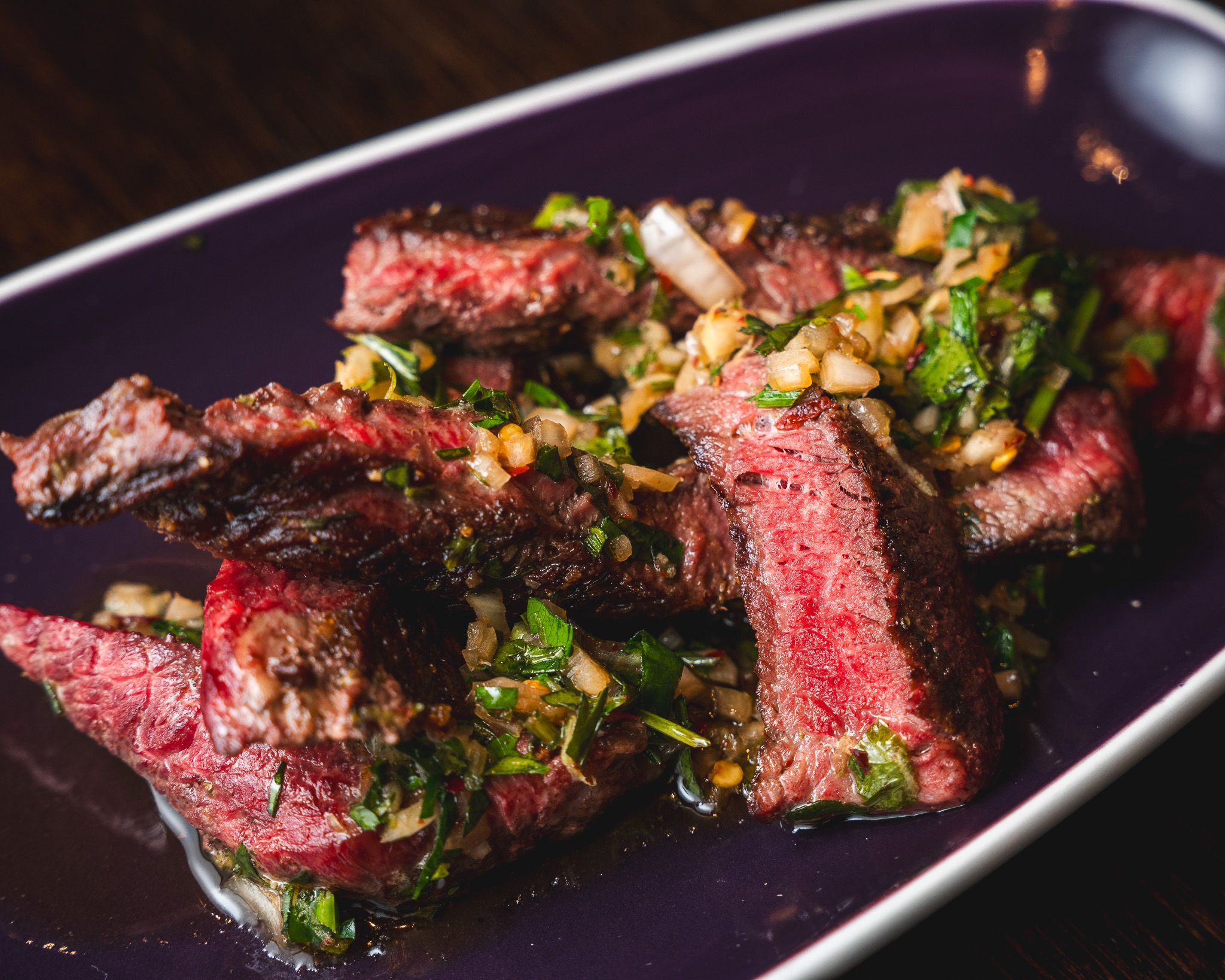 Sliced steak with roasted vegetables and herbs