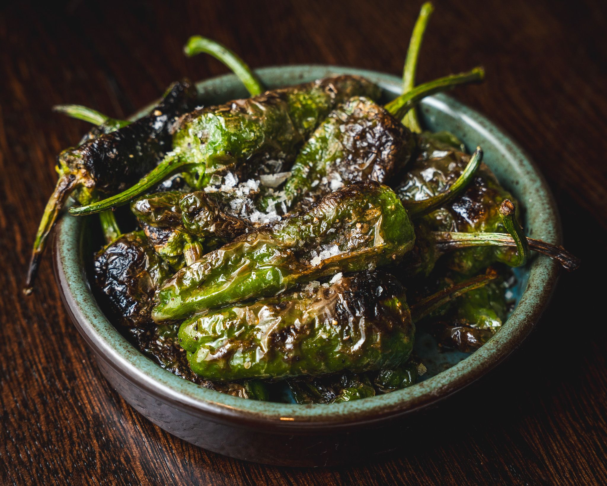 Blistered padrón peppers sprinkled with sea salt