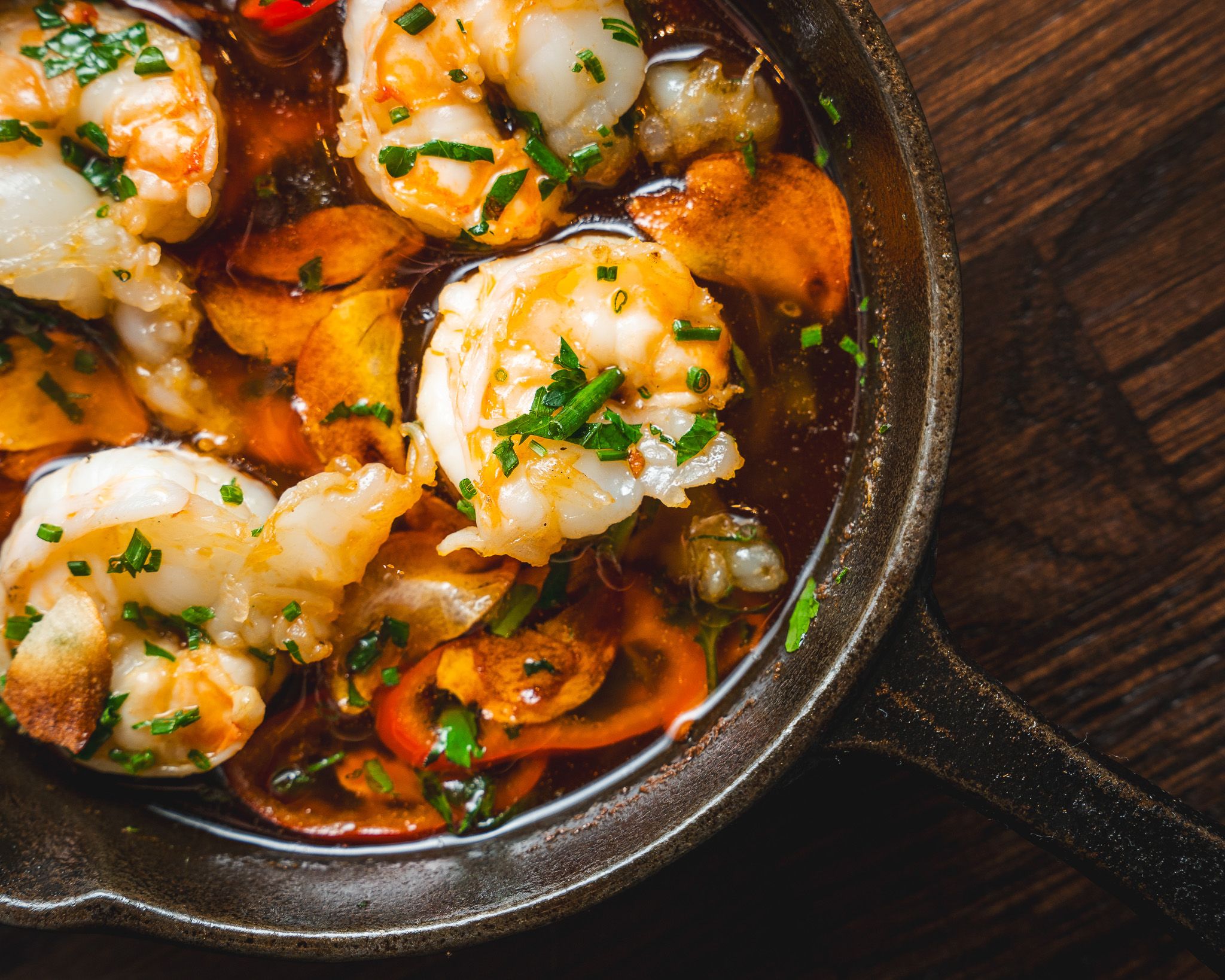 Garlic prawns sizzling in a traditional pan